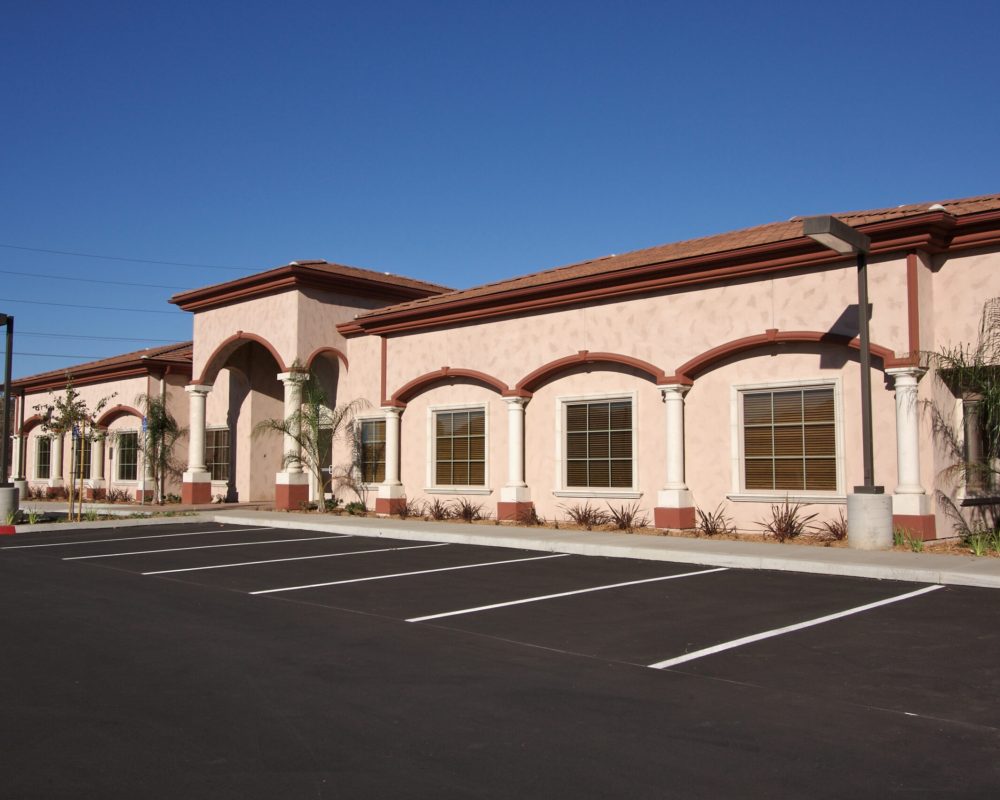 New Vacant Retail Building and Empty Parking Lot. New Vacant Retail Building and Empty Parking Lot.